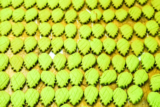 Top view of green pineapple's shape cookies background and wallpaper on wooden table