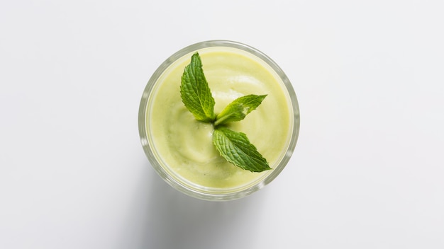 Top view green smoothie in glass with mint