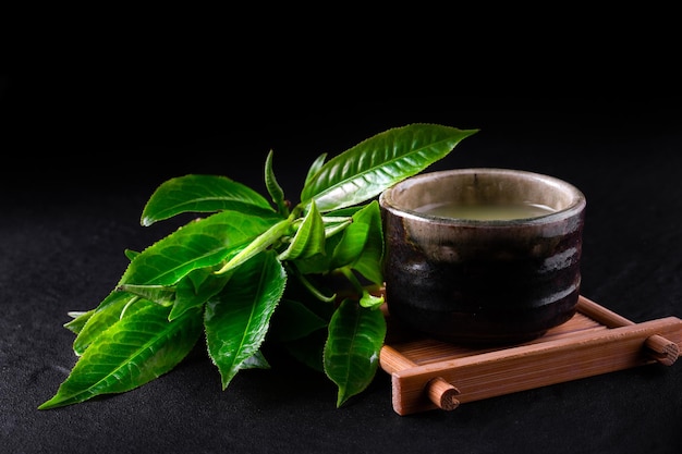 Top view of green tea matcha in a bowl on wooden surface