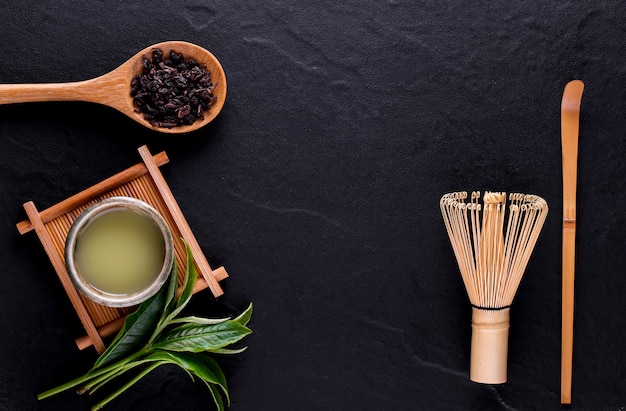 Top view of green tea matcha in a bowl on wooden surface