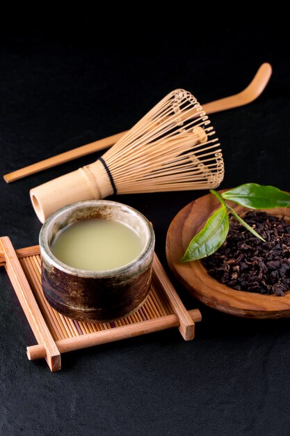 Top view of green tea matcha in a bowl on wooden surface