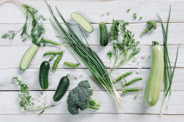 Top view of green vegetarian food on dark rustic table