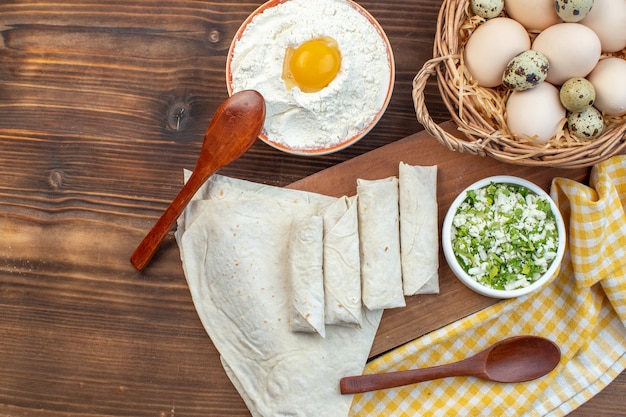 top view greens pita rolls with eggs and flour