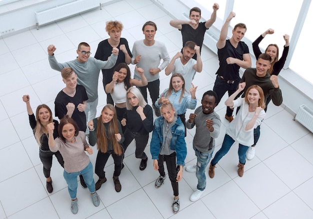 Top view a group of applauding young people looking at the camera