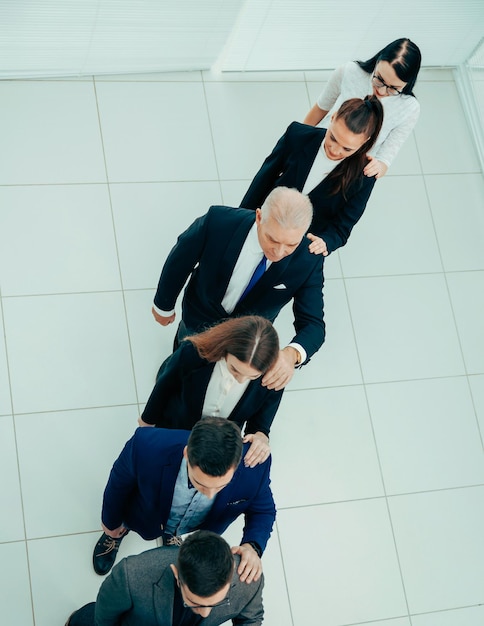 Top view. a group of business people looking at their smartphone screens. photo with a copy of the space