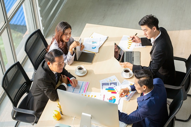 Top view of group of multiethnic busy people working in an office