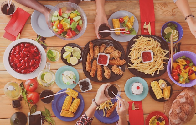 Top view of group of people having dinner together while sitting at wooden table food on the table p