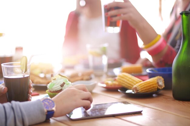 木製のテーブルに座って一緒に夕食を食べている人々のグループの上面図テーブルの上の食べ物人々はファーストフードを食べる