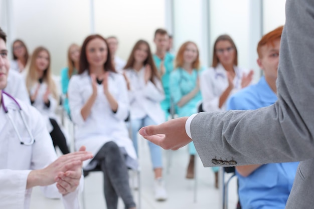 Top view a group of smiling doctors pointing at you