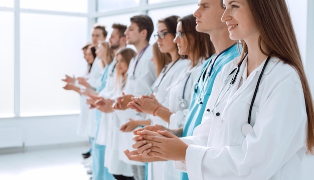 Top view a group of smiling doctors pointing at you