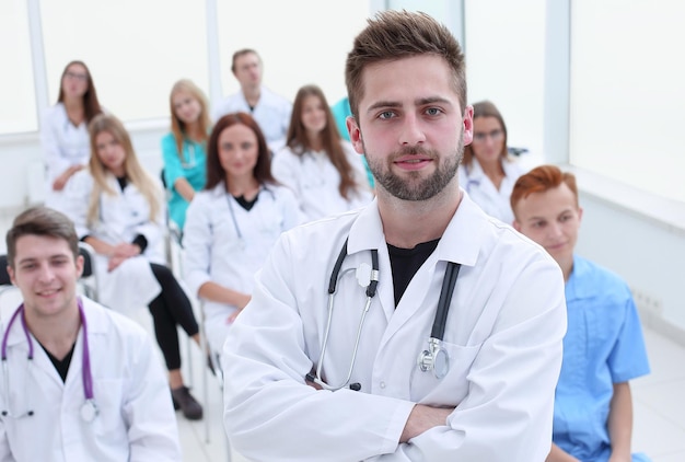 Top view a group of smiling doctors pointing at you