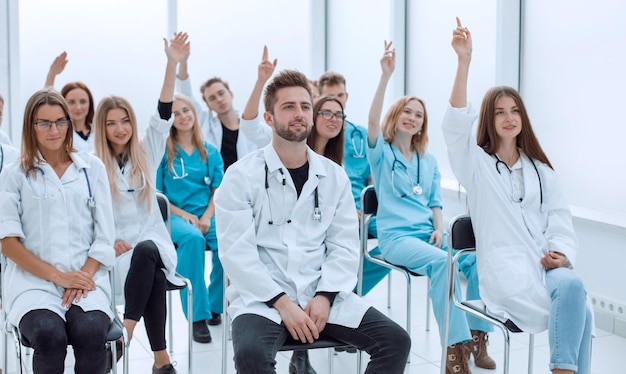 Top view a group of smiling doctors pointing at you