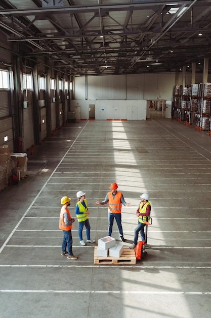 Top view group of workers engineers loaders wearing hard hats work wear vests