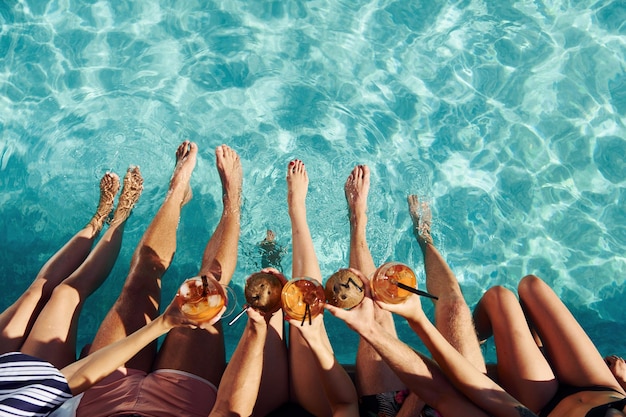 Top view of group of young happy people that have fun in swimming pool at daytime