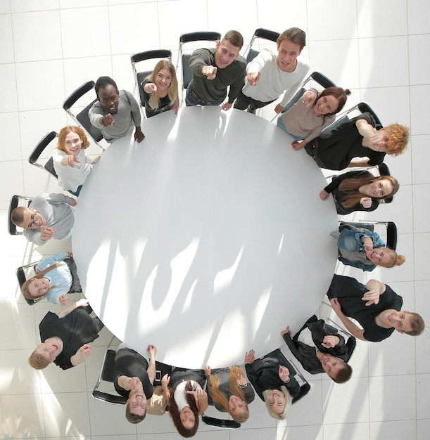 Top view a group of young people applaud at a group\
meeting