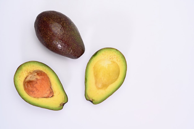 Top view half avocado isolated on white background.