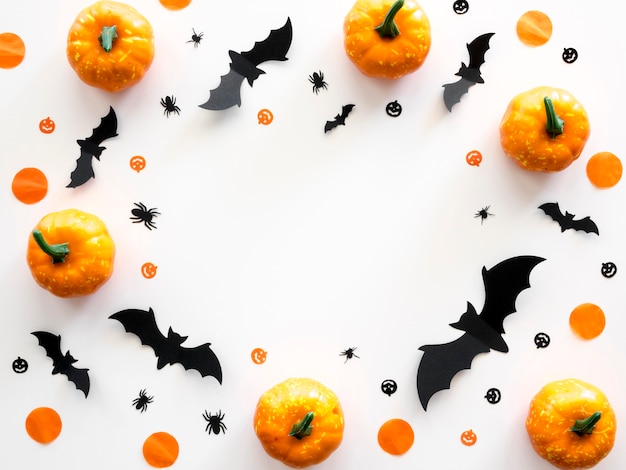 Top view halloween concept with pumpkins and bats