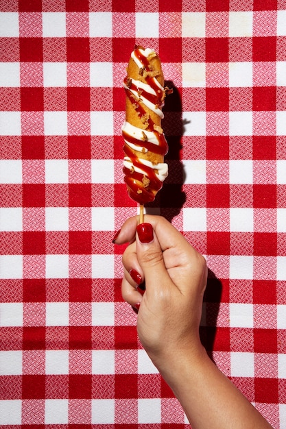 Top view hand holding corn dog