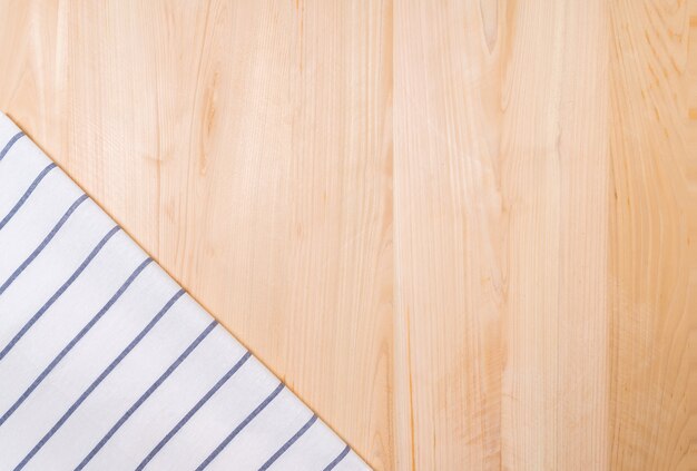 Top view of hand towel and wooden background