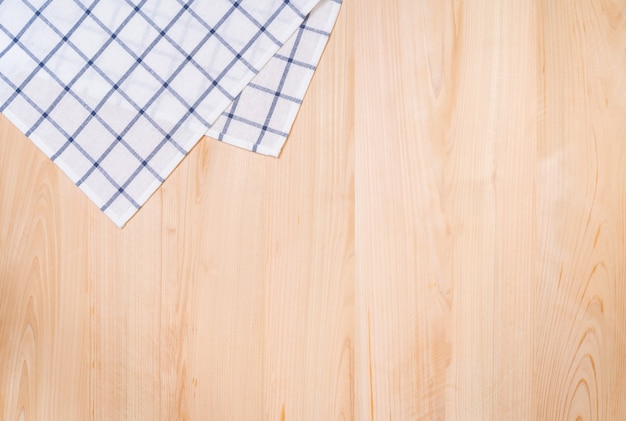 Top view of hand towel and wooden background