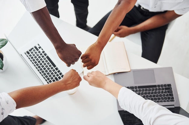 Top view of hands doing success gesture Group of african american business people working in office together