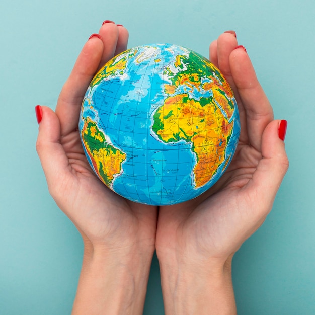 Top view of hands holding earth globe