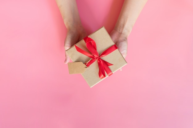 Top view of hands holding a gift box