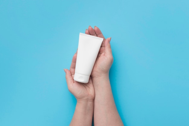 Top view of hands holding hydro alcoholic gel bottle