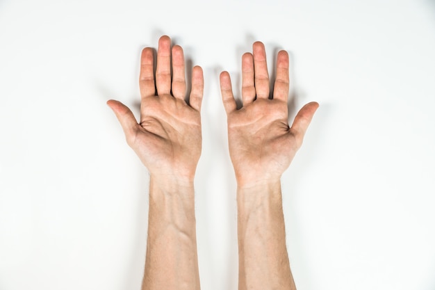 Top view of hands of man on white table