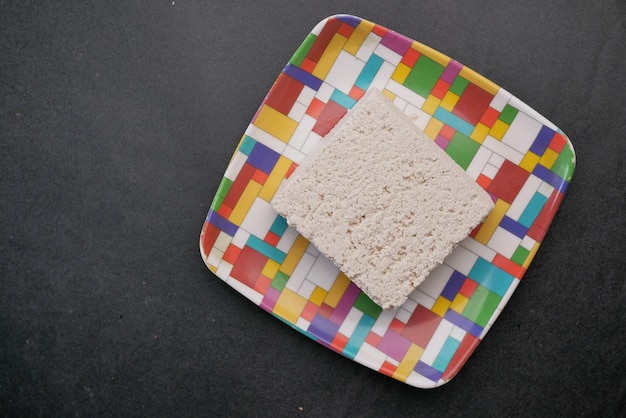 Top view of hands tofu on a plate on table