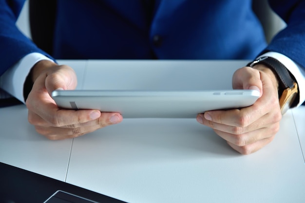 Top view of hands using tablet computer