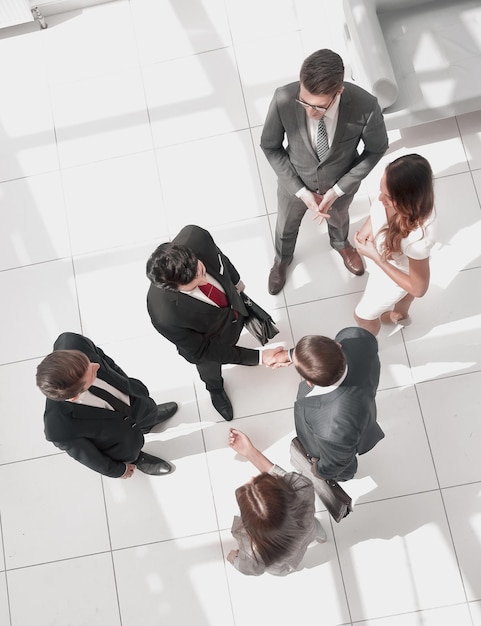 Top view handshake business partners at the meeting