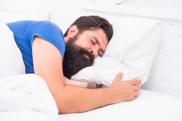 Top view of handsome mature man in shirt sleeping in bed, healthy sleep.