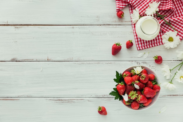 Top view of healthy breakfast with ripe sweet berries and dairy product