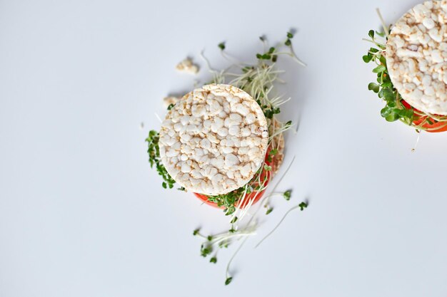 Top view Healthy burger with crispy rice bread vegetables tomato and microgreens