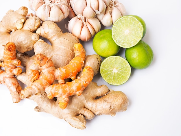 Top view of healthy vegetable set with ginger, turmeric, garlic and lemon, Herbs culinary and medicine isolated on white surface.