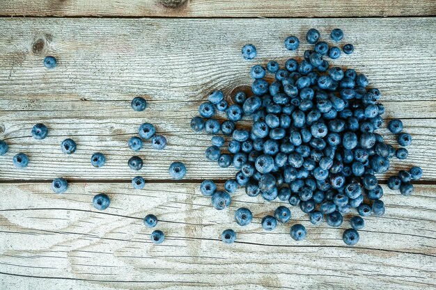 Top view a heap of fresh ripe blueberry on a gray wooden background