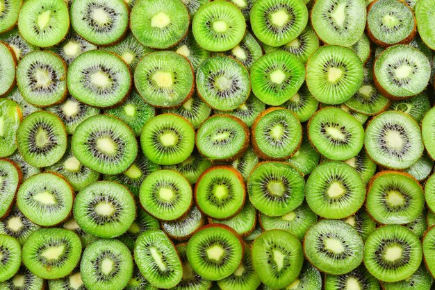 Top view of heap of sliced kiwi as textured background