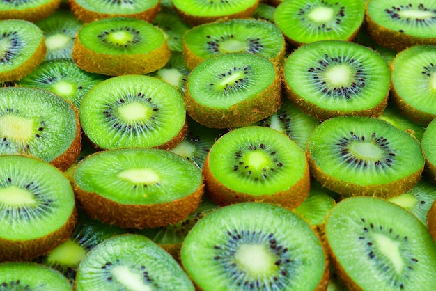 Top view of heap of sliced kiwi as textured background