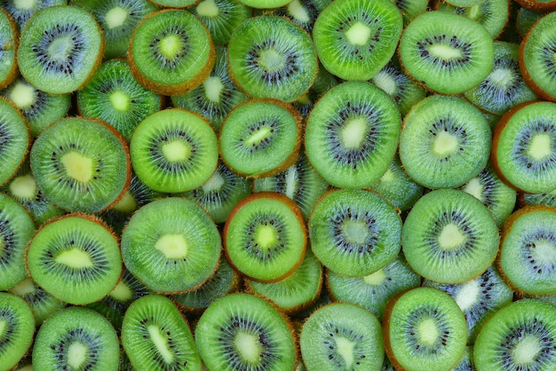 Top view of heap of sliced kiwi as textured background