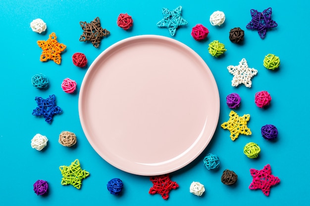 Top view of holiday plate decorated with knitted baubles and stars