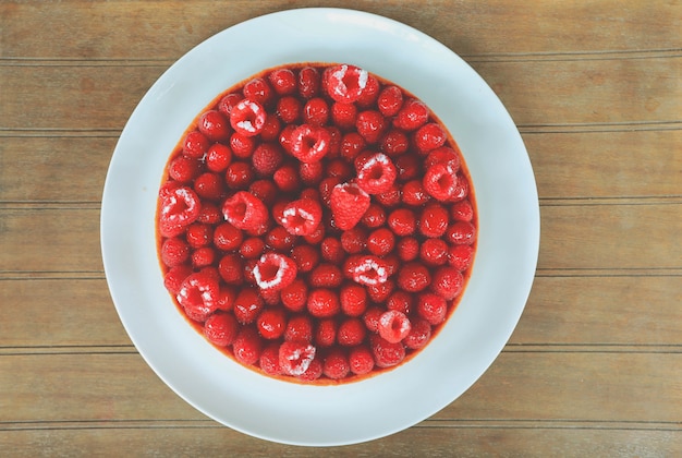 Top view of homemade rraspberries cake on white plate