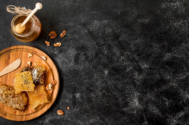 Top view honeycombs with honey jar