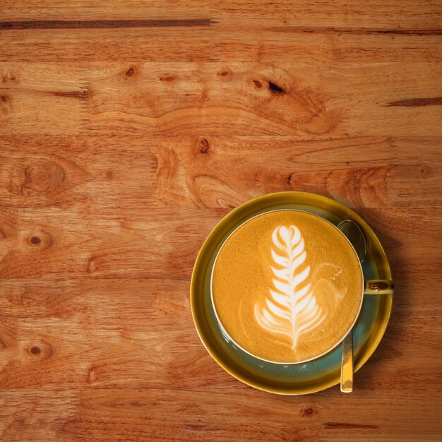 Top view of hot coffee cup on old wood table background