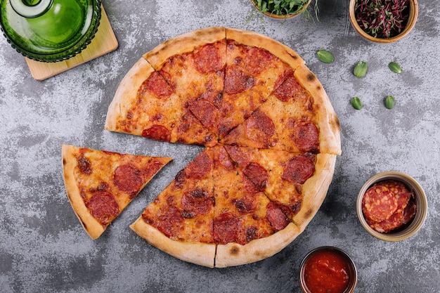 Top view of hot pepperoni pizza on stone