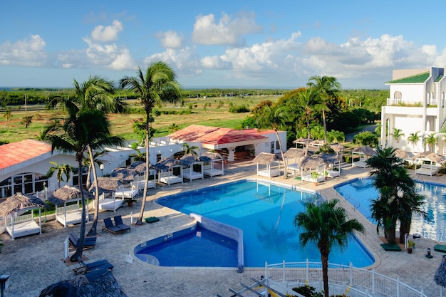 Вид сверху на бассейн отеля вокруг пальмы