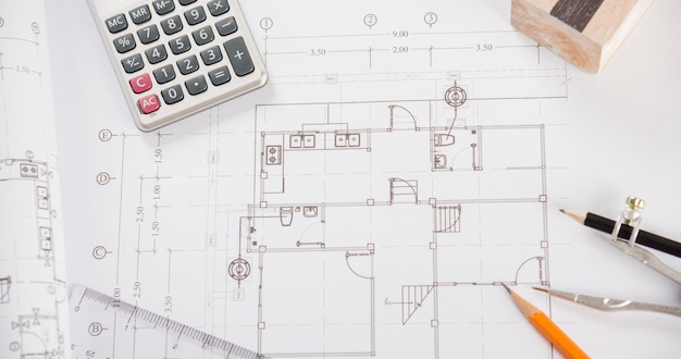 Top view of house plan blueprint paper with repair tools on\
table desk at architecture office