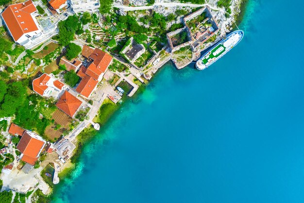 Top view of houses with red tiled roofs near the sea