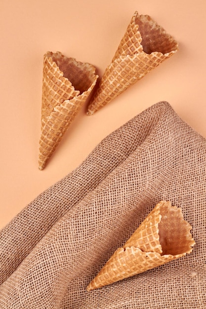 Top view of ice cream waffle cones and burlap cloth