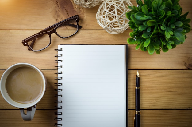 Top view image of open notebook on wooden table.